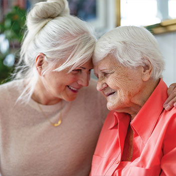 Woman smiling and hugging her elderly mother. Read about Gifts by Estate Note Woman smiling and hugging her elderly mother. Read about Gifts by Estate Note